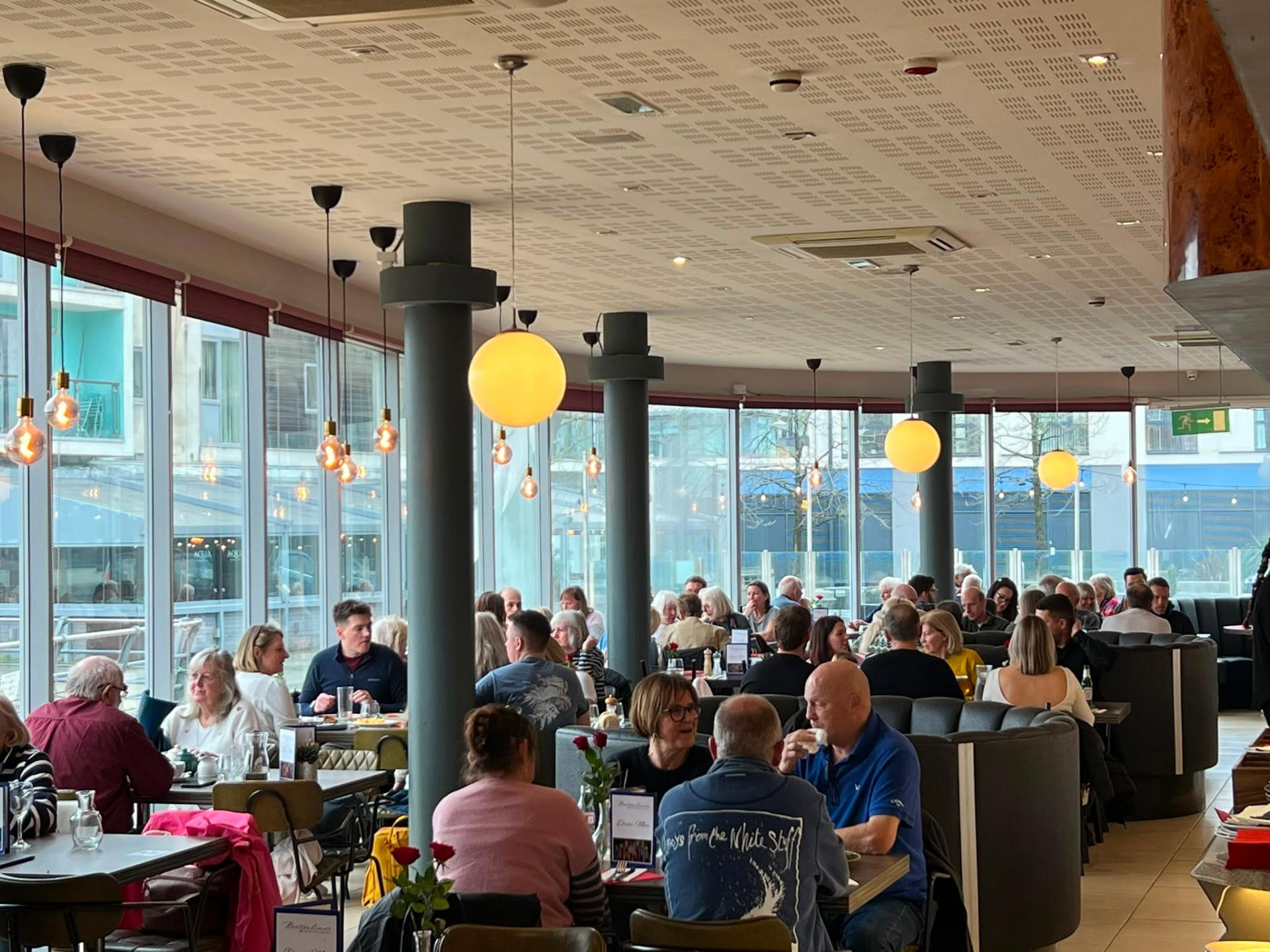PortoBello dining room full of guests with light streaming through the windows